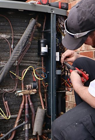 Service repair being done on a heat pump hvac system
